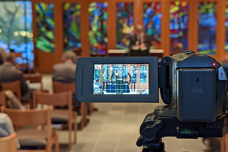 A video camera capturing 2022 Homecoming in the Augustana Chapel