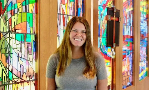 Lyndsay Monsen smiling with stained glass in the background