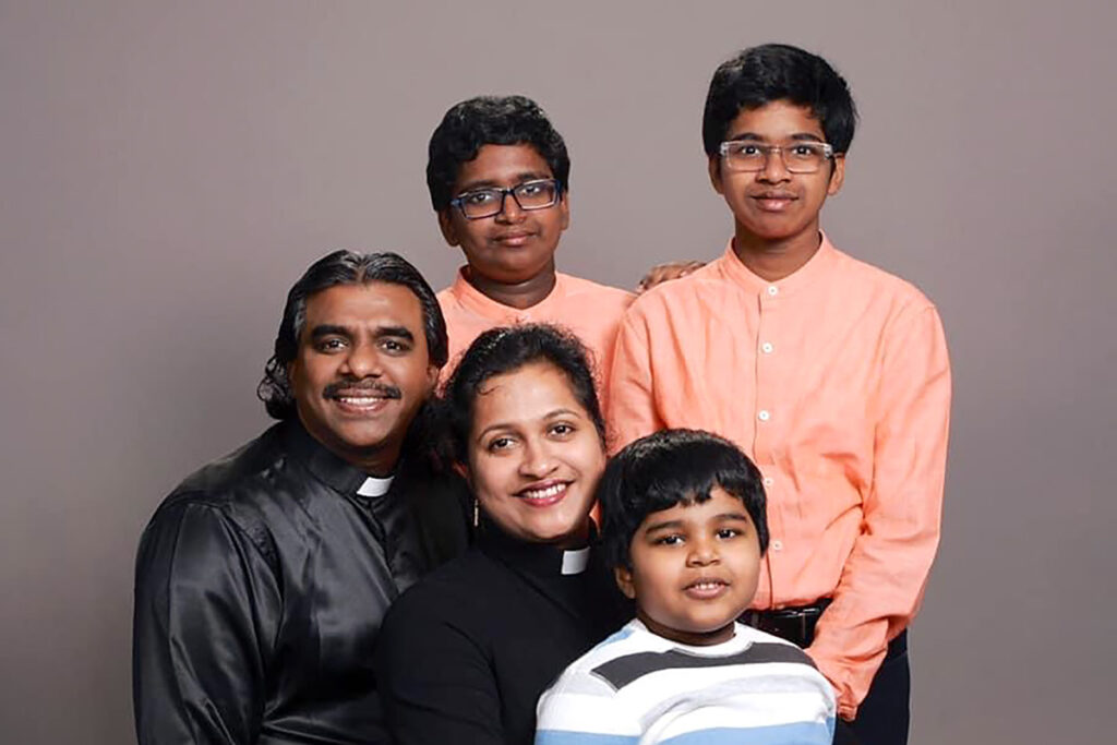 A portrait of the Gunthoti family with Smitha, Manoj, and their three sons.