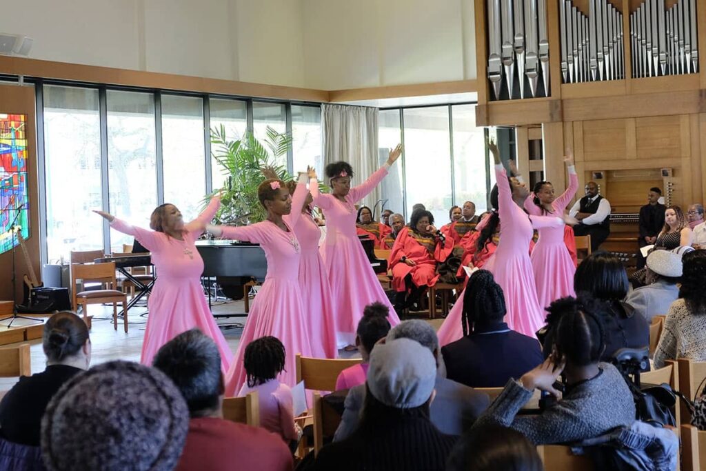 Six women in long flowy dresses dancing at the LSTC Gospel Choir Benefit Concert