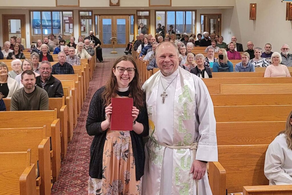 Incoming MDiv Student Madelyn Anderson (center) with her pastor at Faith Lutheran Church in Iowa
