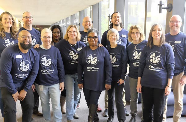 A group of LSTC faculty poses in matching t-shirts on Giving Day.