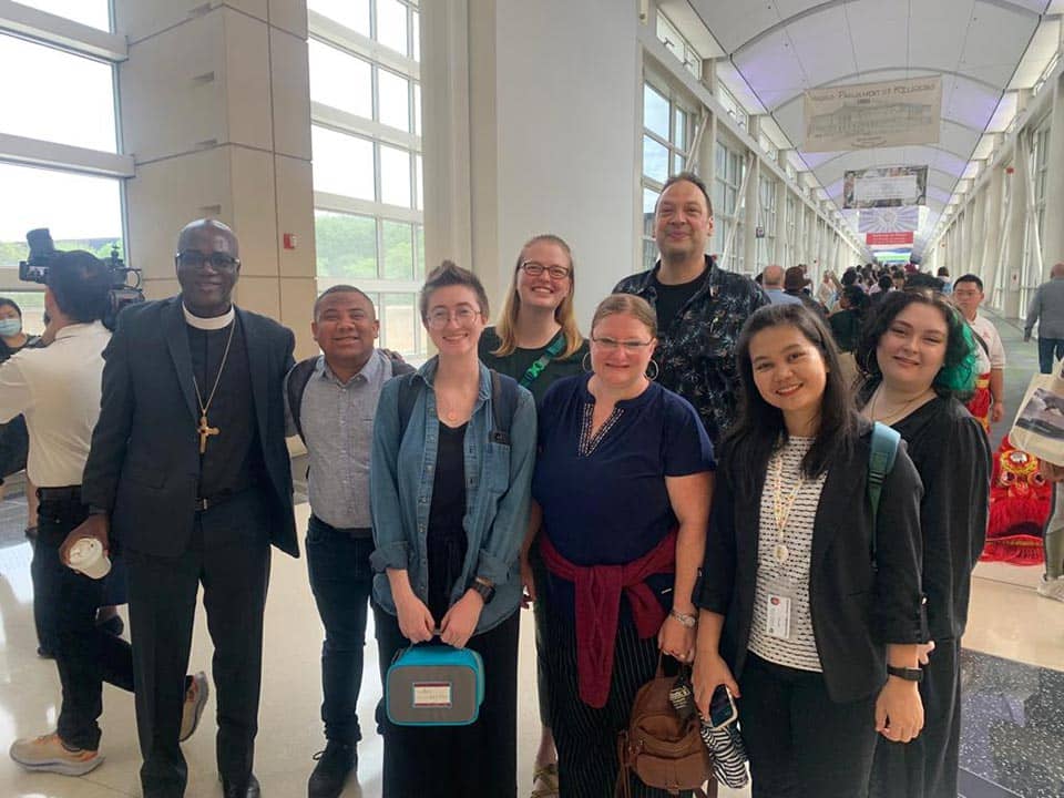 A group poses with Bishop Curry at the Parliament of the World’s Religions