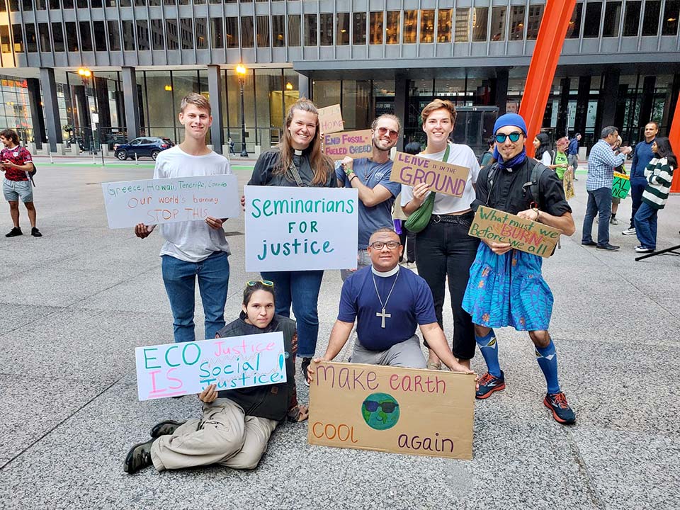 Juan Manuel Perea and other LSTC students hold signs protesting for eco justice in Chicago's Federal Plaza