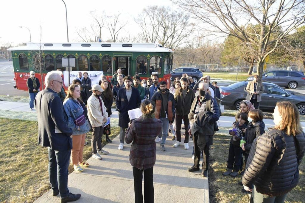 Group outside of the Dar-us-Sunnah Masjid and Community Center in Evanston with the trolley in the background