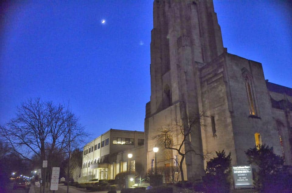 The exterior of Grace Lutheran Church under a moonlit sky