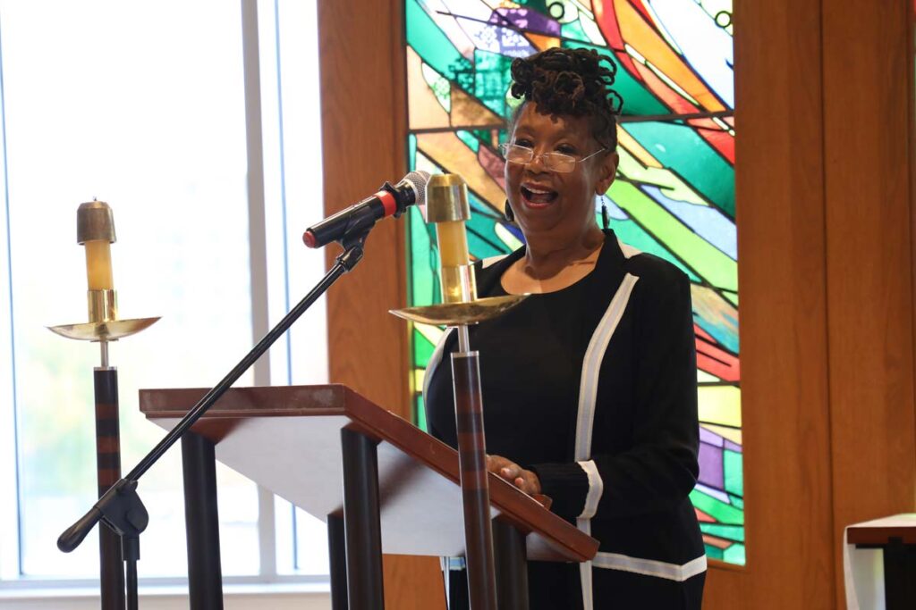 Dr. Linda Thomas speaking at the podium in the LSTC Chapel