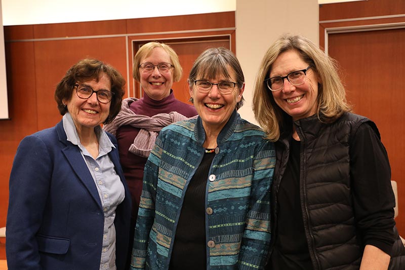 Four women smiling at the World Mission Institute event