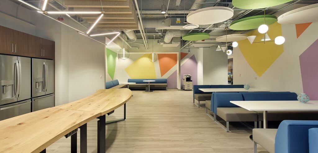 The campus lounge with comfortable seating and colorful shapes on the wall.