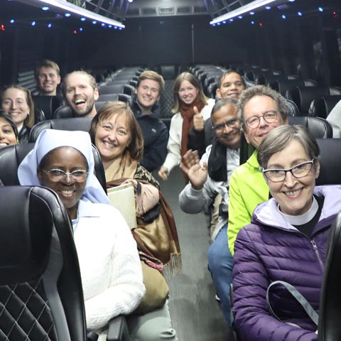 Participants traveling by trolley during an interfaith tour.