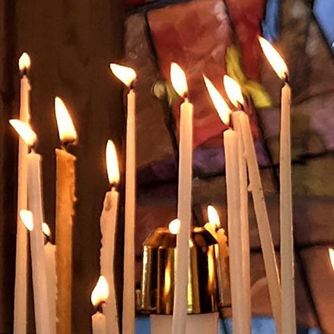 A collection of lit candles in the LSTC chapel.