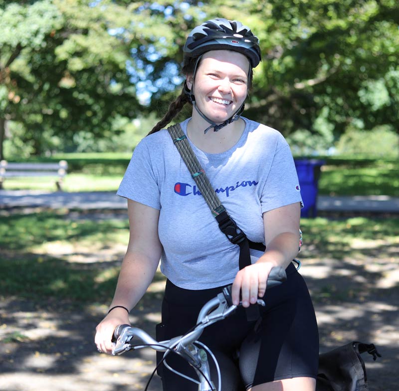 An incoming student smiling on her bike at Promontory Point during orientation.