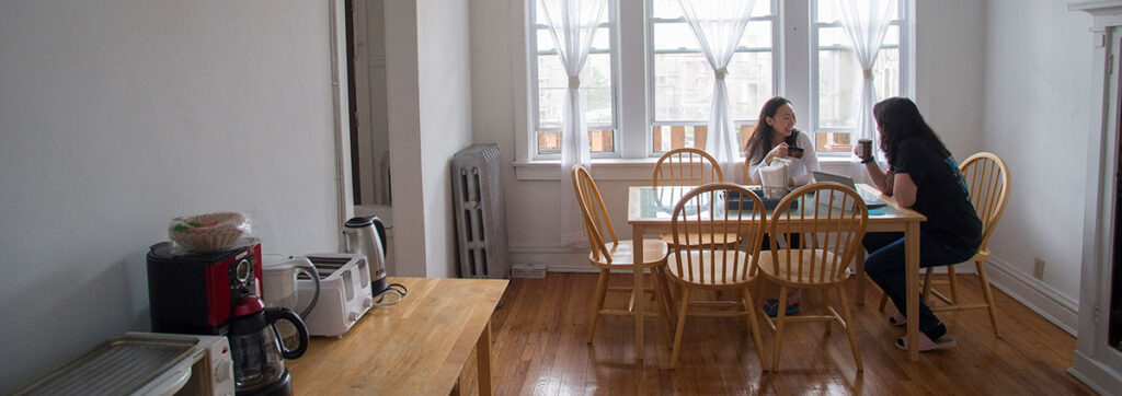 Two LSTC students studying at their dining room table.