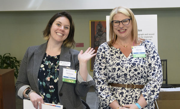 Two staff members give out nametags at LSTC's Seminex conference.