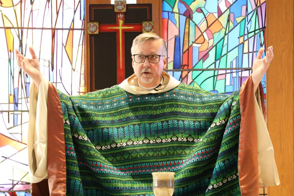 LSTC President Jim Nieman lifting his hands up while leading service in the LSTC chapel.