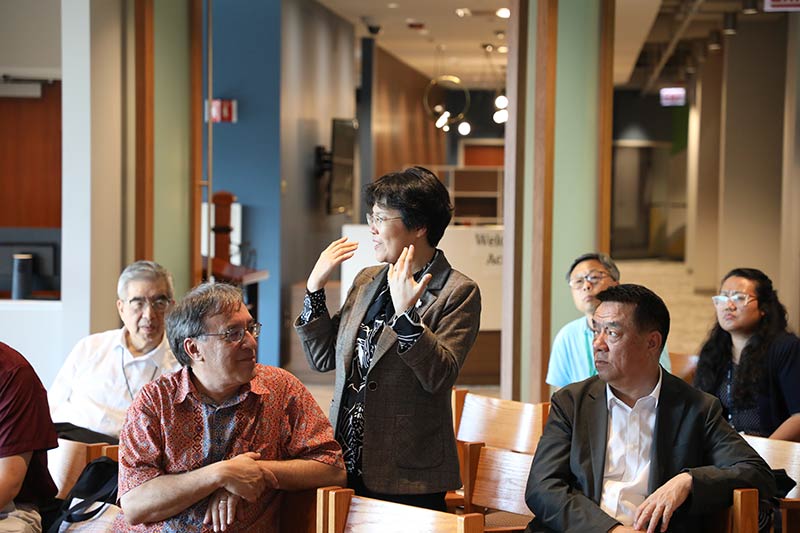 A woman in the audience stands up to speak during a visit from the delegation representing the China Christian Council (CCC) and the Three-Self Patriotic Movement of the Protestant Church.