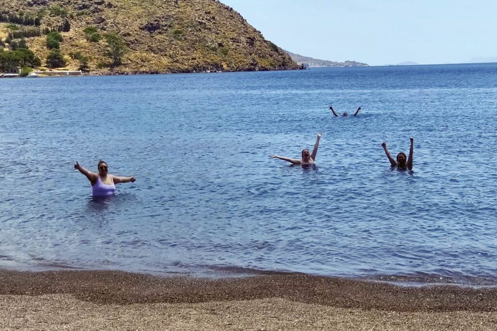 Kylee Bestenlehner, Emily Moentmann, and Adam Groenke swim with a friend in the Aegean Sea.