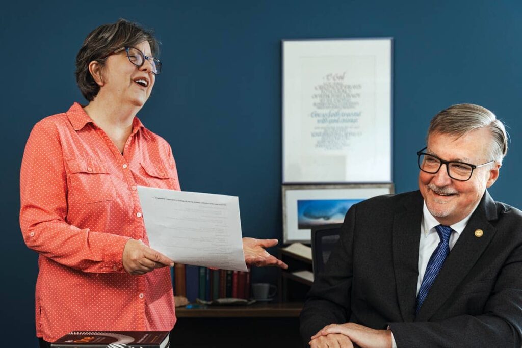 Assistant to the President Patti DeBias speaks with President James Nieman.