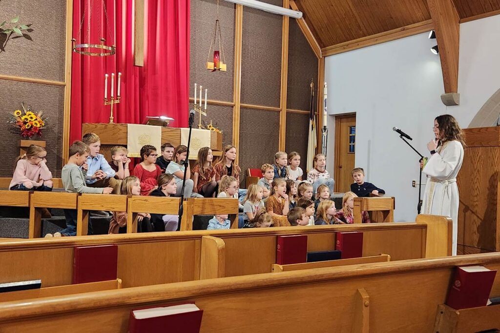 LSTC alum Amber Kalina addresses a youth group in church.