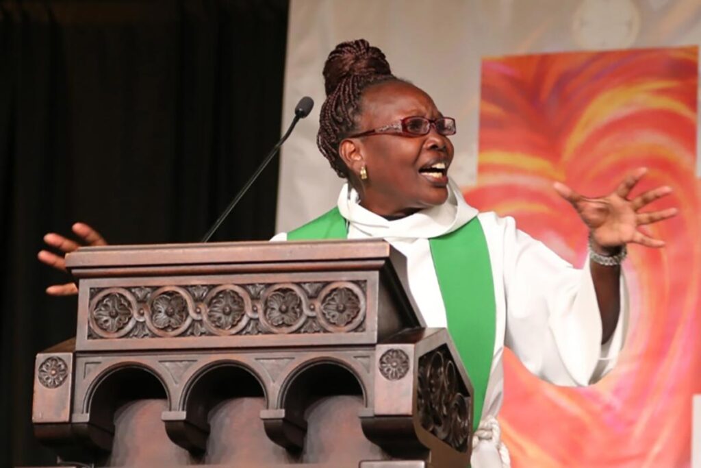 Rev. Dr. Mary Tororeiy preaching in a church.