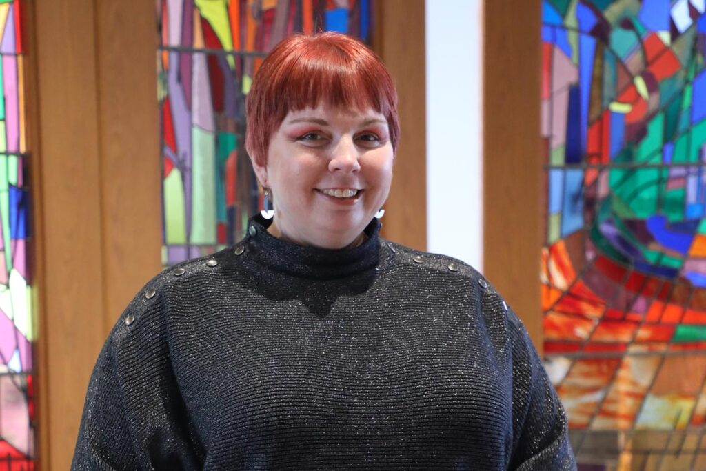 Dr. Karri Alldredge smiling from the LSTC Chapel podium.