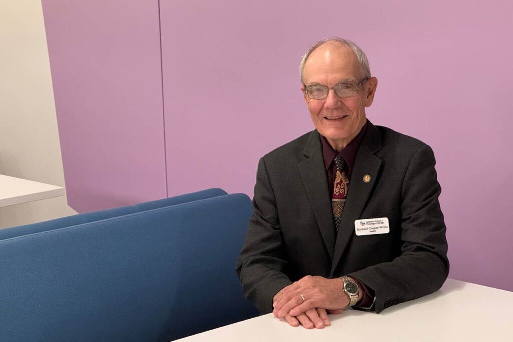 Interim President Michael Cooper-White smiling while sitting in the LSTC lounge.