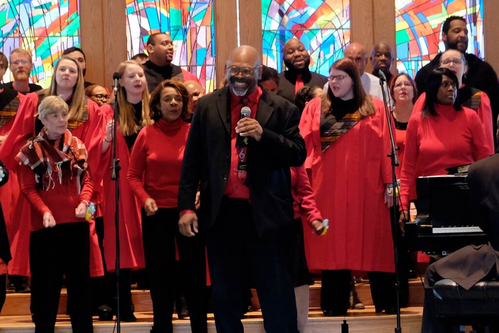 Conductor Dr. Keith Hampton with the choir behind him in the LSTC Chapel.