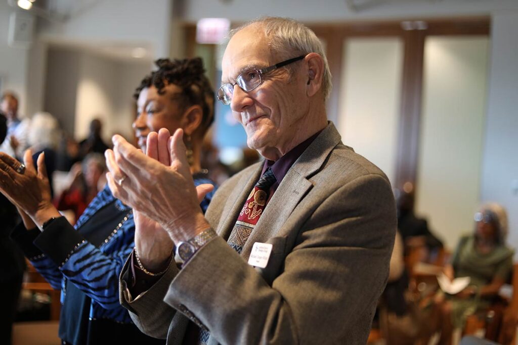 Interim President Michael Cooper-White applauding in the LSTC Chapel.