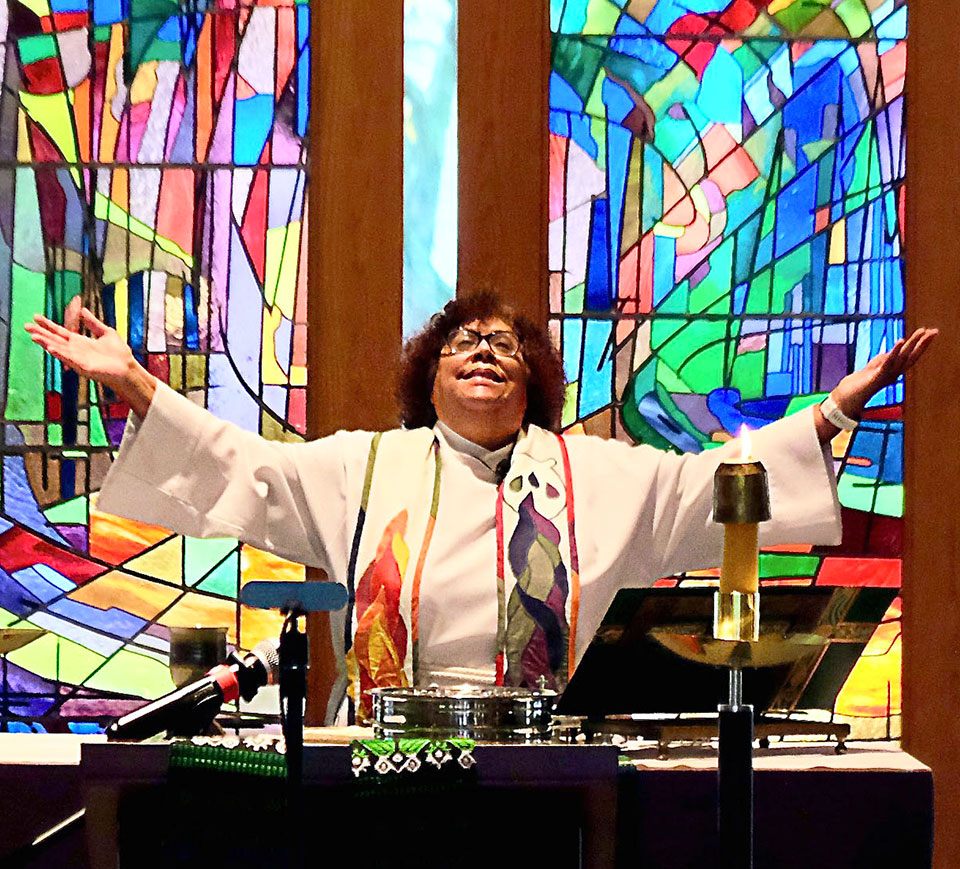 Communion conducted in the Augustana Chapel during 2022's Homecoming.
