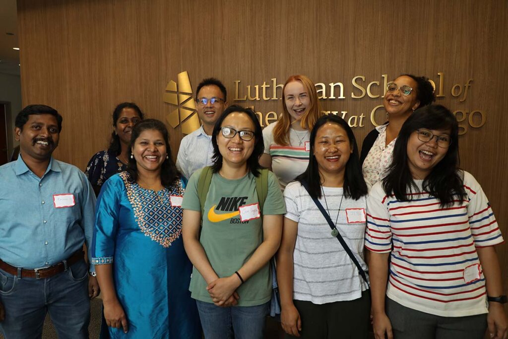 A group shot of smiling new students at LSTC's campus.