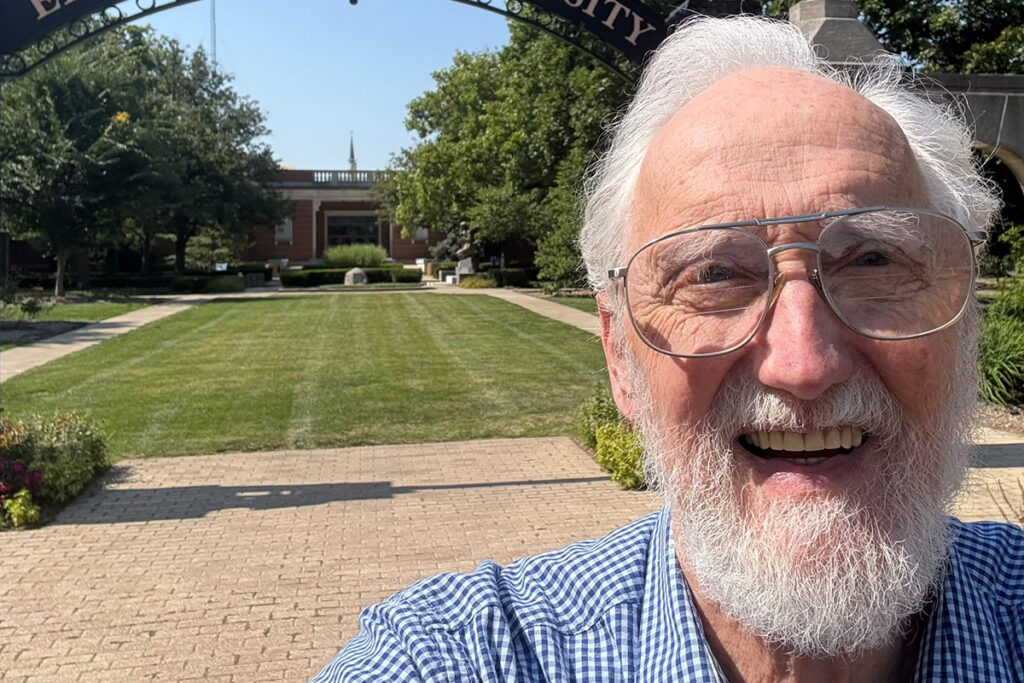 Jim Marcum at the gate of Elmhurst University.
