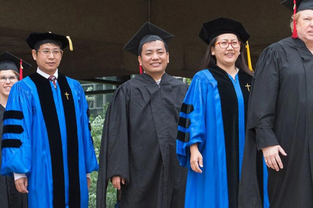 Rev. Dr. Si Khaw at graduation in his cap and gown.