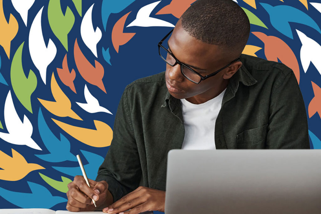 A Project Starling student working diligently with the project logo behind him.